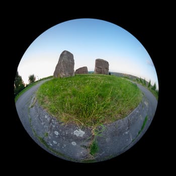 Road and three rocke on green meadow with fish-eye distortion