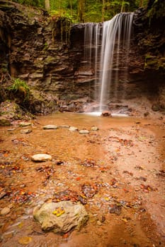 Waterfall stream cascade scene in vertical format