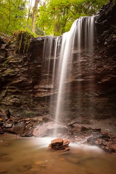 Waterfall cascade flowing over a rock in a forest