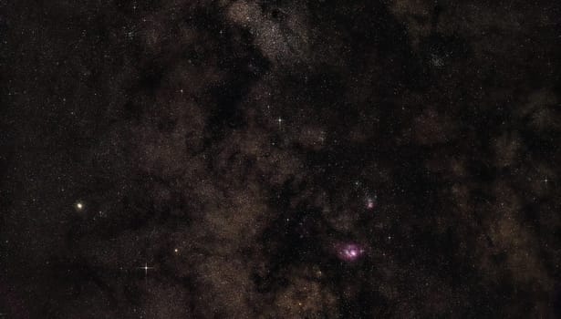 Night sky with milky way near Sagittarius constellation, bright Kaus Borealis star and M22 globular cluster left side, purple Lagoon and Trifid nebula visible. Long exposure stacked photo.