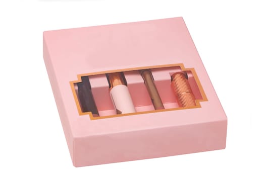 Cosmetic products. Close-up of various items of cosmetics without label in a pink package isolated on white background. Promotional spa, make-up and beauty concept.