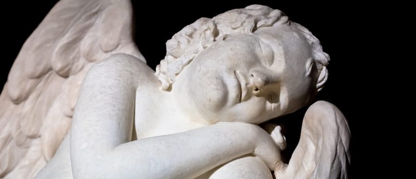 MILAN, ITALY - CIRCA AUGUST 2020: Cute sleeping angel. Statue made in marble, end of 18th century, unknown sculptor. Concept for sleep, innocence and newborrn.