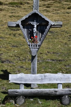 An old,gray wayside cross in the Alpine region of Austria,Germany,Switzerland.