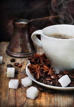 Coffee cup and old-fashion coffee pot on wooden plank