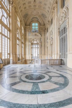TURIN, ITALY - CIRCA JUNE 2021: The most beautiful Baroque hall of Europe located in Madama Palace (Palazzo Madama). Interior with luxury marbles, windows and corridors.