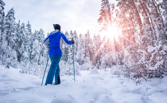 Skier foots in skis in the snowy winter forest. Concept of vacation and weekend.
