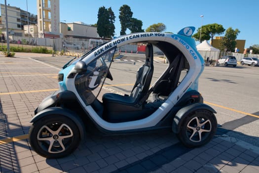 Civitavecchia, Italy - December 19, 2024: An eco-friendly electric vehicle in Civitavecchia, serving as an information car for tourists. The compact design enhances urban mobility and convenience.