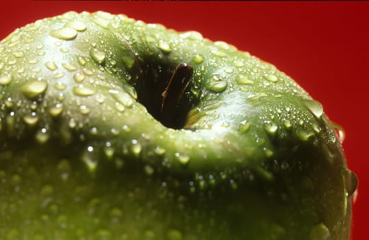 green, sweet apple splashed with water