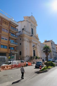 Civitavecchia. Italia - December 19, 2024: A sunny day in Civitavecchia, Italy, featuring a historic church and urban surroundings. Concept: History, modernity, cityscapes.