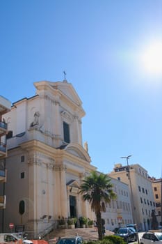 Civitavecchia. Italia - December 19, 2024: The facade of a historic church in Civitavecchia, Italy, surrounded by modern urban structures. Concept: Harmony, old, new architecture.