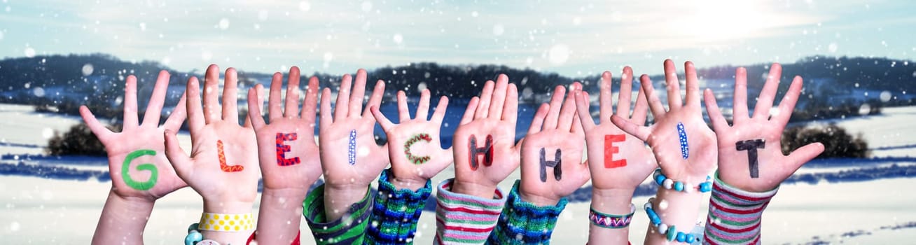 Children Hands Building Colorful German Word Gleichheit Means Equality. Snowy Winter Background With Snowflakes