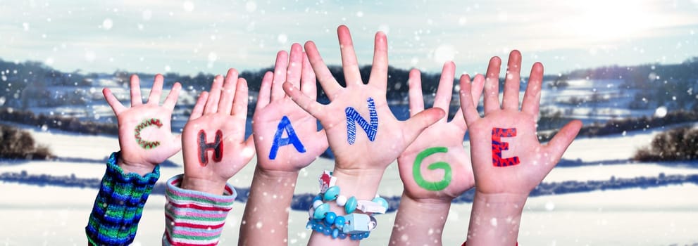 Children Hands Building Colorful Word Change. Snowy Winter Background With Snowflakes