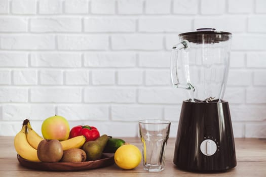 Blender with ingredients for smoothie on table in kitchen. Kitchen appliances