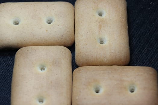 Close up top view of of biscuit cookies. Close up view rectangular biscuits with small pores