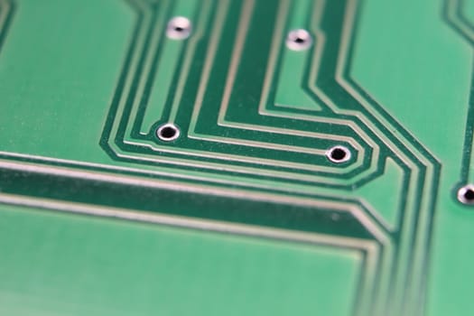Electronic board with circuit lines and chip. Macro view of green board