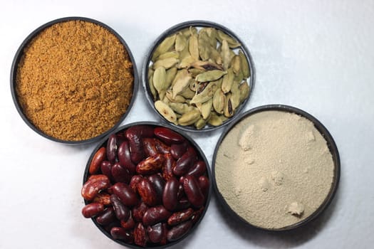 Top view of assortment of cereals, and cardamom. Collection of different spices and cereals.