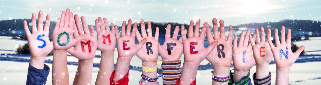 Children Hands Building Colorful German Word Sommerferien Means Summer Holdiays. Snowy Winter Background With Snowflakes
