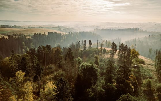 Aerial view of autumn sunrise countryside, traditional fall landscape with rising sun in Central europe. Foggy and misty sunrise. Frozen landscape from bird eye. Czech Republic,Vysocina highland