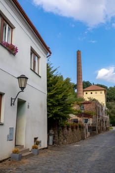 Narrow picturesque street with colorful buildings in historic center in medieval city Trebic, aisle in renaissance and baroque historical buildings at jewish quarter. Czech Republic