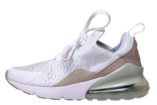 Closeup of a single white elegant stylish female leather high-heeled sport shoes isolated on a white background. Womens shoe fashion. Clipping path. Modern design footwear for workout. Macro.
