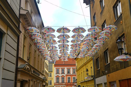 BRATISLAVA, SLOVAKIA - JUNE 8, 2020: Umbrellas above the street in Bratislava's Old Town district. Umbrellas hang in rows on the street as a decoration.
