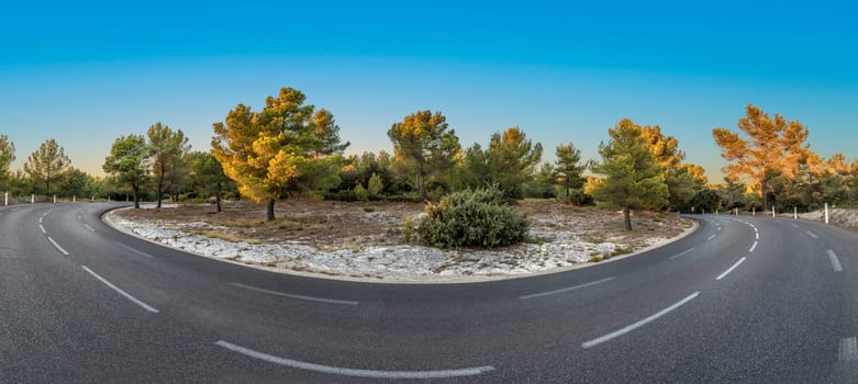 curvy street in rural landscape in the provence, France