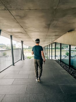 A vizh behind a walking man in casual clothes