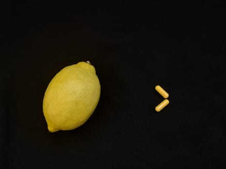Yellow lemon and two yellow casulas on a black background, view from above, copy the space for your text