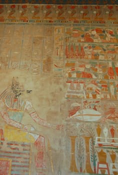 Anubis god and colorful murals in Hatshepsut temple, Egypt