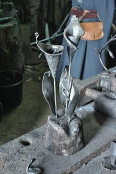 In the workshop at the blacksmith's flower calla forged from metal
