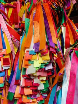 Many colorful ribbons with wishes hangs in the temple. Georgetown, Penang, Malaysia, colorful background