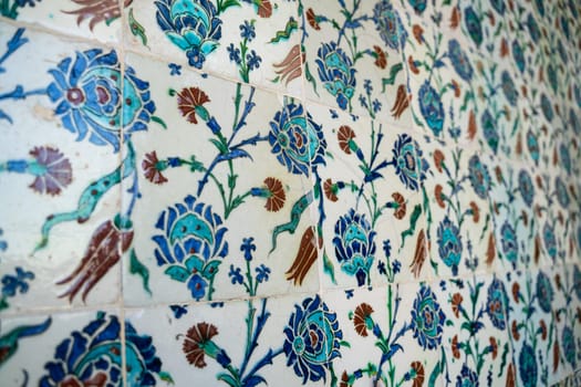 front view close up of Islamic ottoman era blue ceramic ornament tiles with flowers in Topkapi Palace museum Istanbul