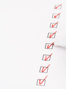 Red colored checkmarks in little black boxes, white paper, education, test, to do list, busniss concept
