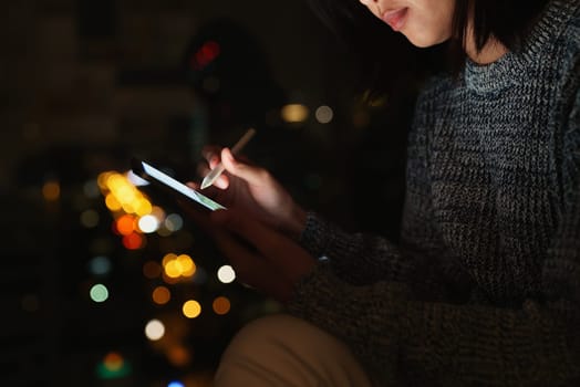 Using stylus pen on digital tablet at night, lifestyle at night in city