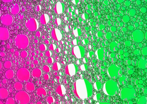Magenta and green bubbles background. Foam bubbles macro texture.