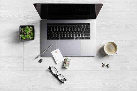 Online work concept. Office supplies and gadgets on wooden background. Flat lay.