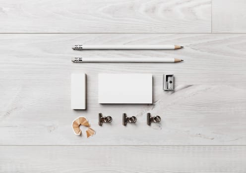 Photo of blank stationery set on wooden background. Blank stationery template for branding identity for designers. Flat lay.