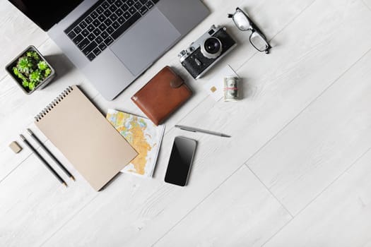 Blank stationery, laptop and travel accessories with copy space. Flat lay.