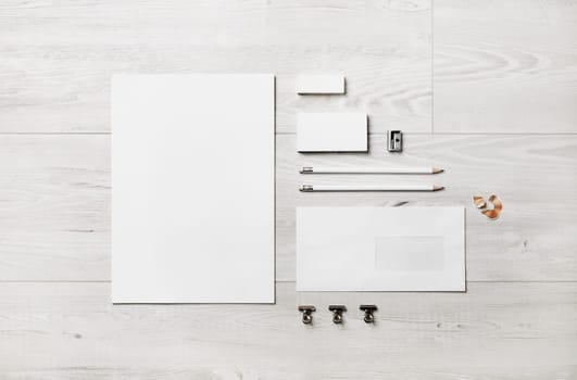 Blank corporate stationery set on wood background. Template for branding identity. Flat lay.