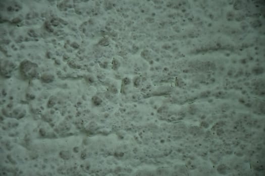 Wall of concrete with green plastering