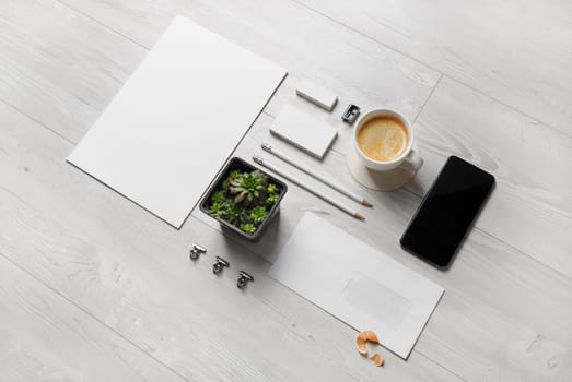 Photo of blank stationery set on wood background. Corporate identity template. Responsive design mockup.