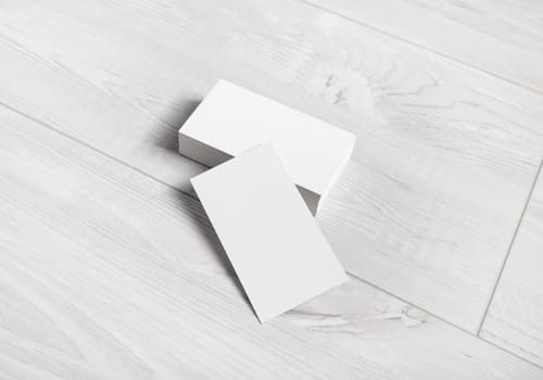 Business cards mockup. Photo of blank business cards on wooden background.