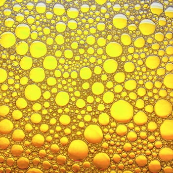 Bubbles on yellow background. Abstract bubbles texture. Flat lay.