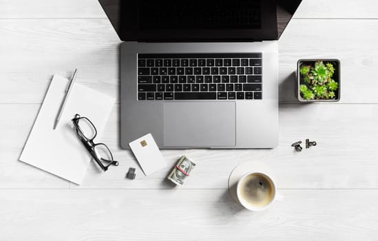 Online e-commerce concept. Workplace with business office supplies and gadgets on wooden background. Flat lay.