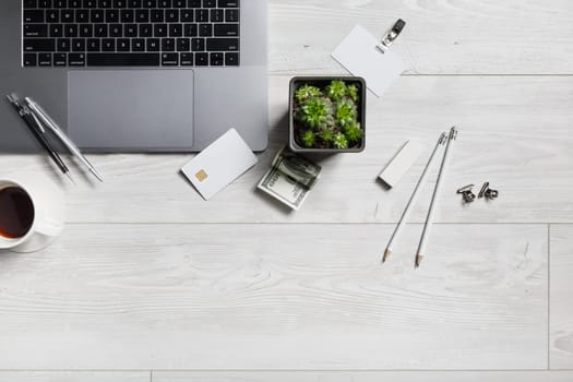 Office workplace with gadgets and stationery on wooden background. Flat lay.
