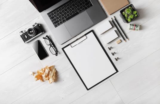 Blank stationery and gadgets on wooden background. Flat lay.