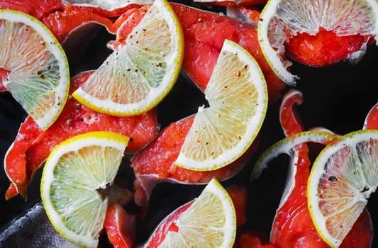 Fresh salmon fish with lemon and seasoning.