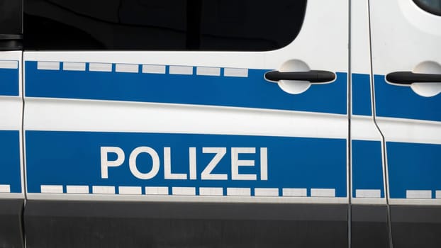 WETZLAR, GERMANY - 2020-12-27: Side view of a typical german police car with lettering "Polizei"" on blue background. Wetzlar, Germany"