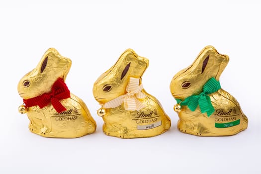 HUETTENBERG, GERMANY, 2021-04-04: Three Lindt Gold Bunny. Dressed in gold, with a ribbon and golden bell that rings, it is the traditional Lindt Easter chocolate.