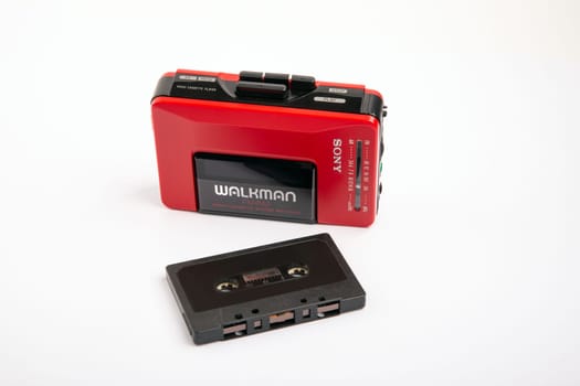 HUETTENBERG, GERMANY - 2021-04-07: Beautiful red vintage SONY WALKMAN WM-24 over bright background.